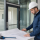 Commercial professional reviewing the fire rating required for commercial glazing at a rated glass door opening.